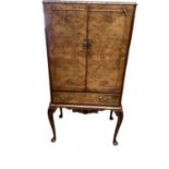 Good quality Queen Anne style cocktail cabinet with fitted interior enclosed by glazed door with dra