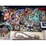Vintage suitcase containing various bead necklaces, two silver and turquoise cross pendant necklaces