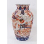 A large Japanese Imari style vase, Meiji period, of fluted baluster form with applied dragon decorat