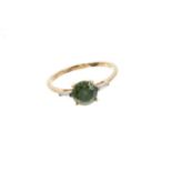 Fancy green diamond ring with a round brilliant cut fancy green diamond (heat treated) estimated to