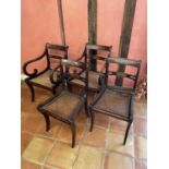 Set of four Regency rosewood and brass inlaid dining chairs, each with bar back and caned seat on re