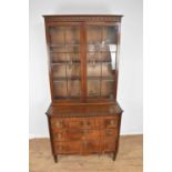 Early 19th century Dutch mahogany chest of drawers with associated bookcase top.