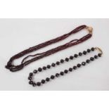 Two antique garnet bead necklaces