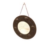 Arts and Crafts circular wall mirror in embossed copper frame