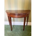 George III mahogany and fruitwood crossbanded demi-lune card table, the fold over top enclosing gree