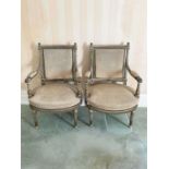 Pair of Louis XVI style painted and gilt wood fauteuils, each fluted showood frame and stud closed u