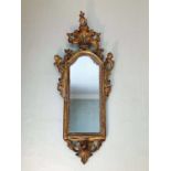 18th century Venetian gilt wood pier mirror, with arched mirrored plate in C- scroll rococo frame wi