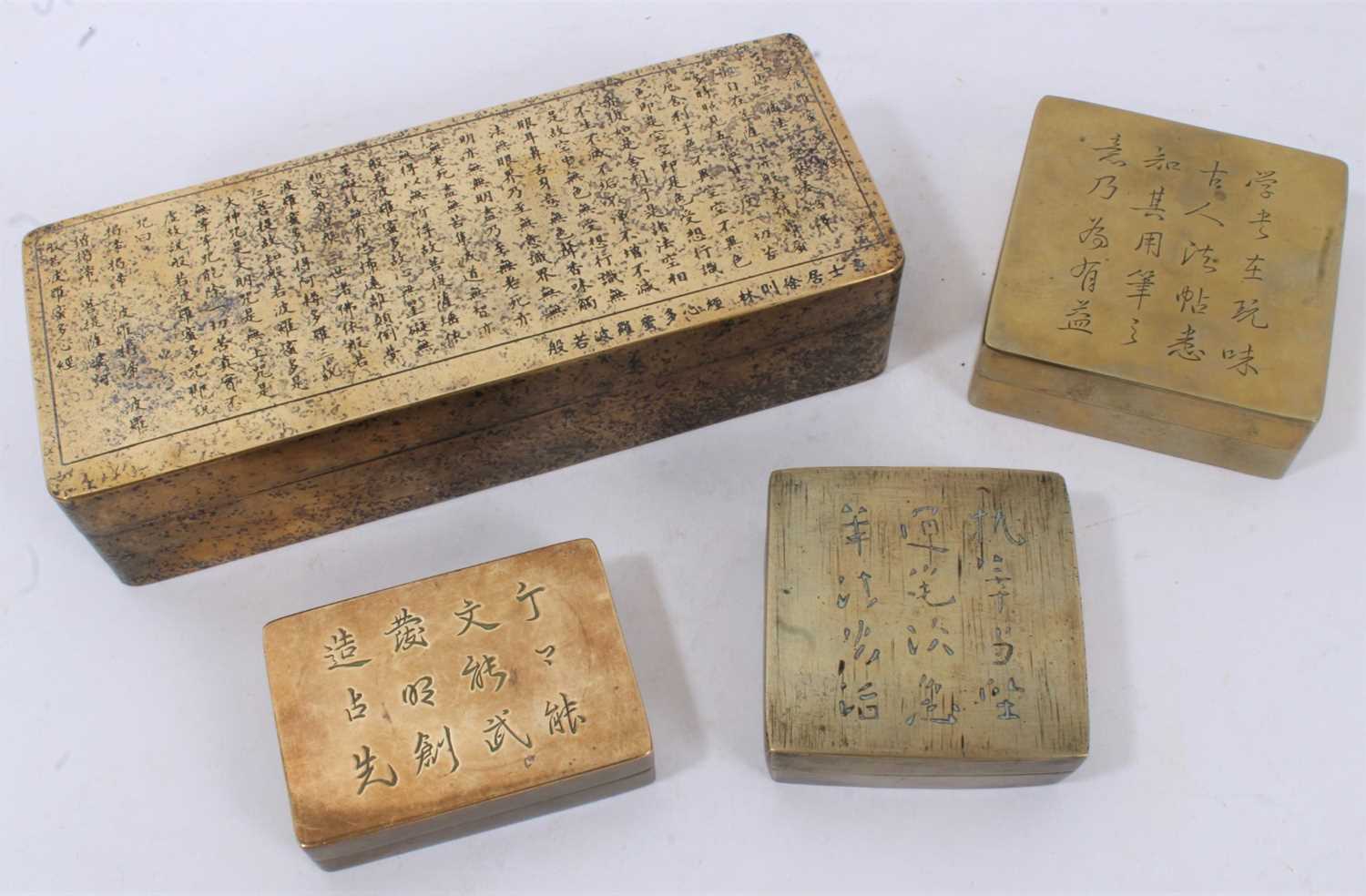 Large Chinese paktong ink box with ornate script panel and gold splash ornament, 19cm long, together