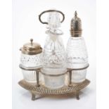 Victorian silver four bottle cruet of elliptical form with reeded frame and central handle