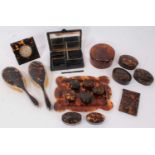 Collection of tortoiseshell dressing table items, desk timepiece, vanity case, pair of silver mounte