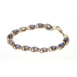 9ct gold and tanzanite bracelet, with oval mixed cut stones in 9ct yellow gold setting, 19cm.