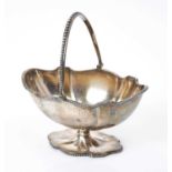 Victorian silver swing handled sugar basket of shaped oval form, with engraved foliate decoration