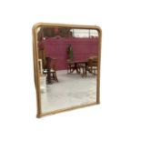 A Victorian gilt overmantel mirror of arched form, 135cm high x 108cm wide