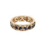 Sapphire and diamond eternity ring with a full band of marquise cut blue sapphires and brilliant cut