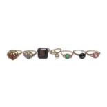 Group of seven gold and yellow metal gem set dress rings