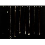 Eight 9ct gold gem set pendants, seven on 9ct gold chains