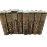 Set of seven Donald A Mackenzie books, with decorative cloth binding, one further decorative binding