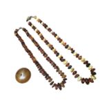 Two amber bead necklaces and a large reconstituted bead