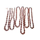Six Chinese oval carnelian bead necklaces with silver clasps, 65cm - 52cm long