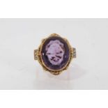 Amethyst and diamond ring with a large oval mixed cut amethyst in gold setting, diamond set shoulder