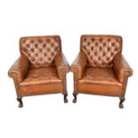Pair of early 20th century leather upholstered club chairs, raised on carved cabriole legs and claw