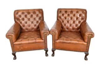 Pair of early 20th century leather upholstered club chairs, raised on carved cabriole legs and claw