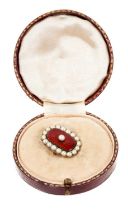 Regency gold enamel and pearl brooch with a central half pearl on red guilloché enamel ground surrou