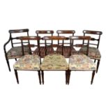 Set of seven Regency mahogany and ebony inlaid dining chairs, including one carver