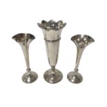 Pair Edwardian spill vases with flared rims and a contemporary silver trumpet vase.