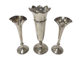 Pair Edwardian spill vases with flared rims and a contemporary silver trumpet vase.