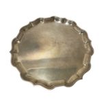 1940s silver salver of hexagonal form, with pie crust border, on three paw feet