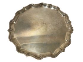 1940s silver salver of hexagonal form, with pie crust border, on three paw feet