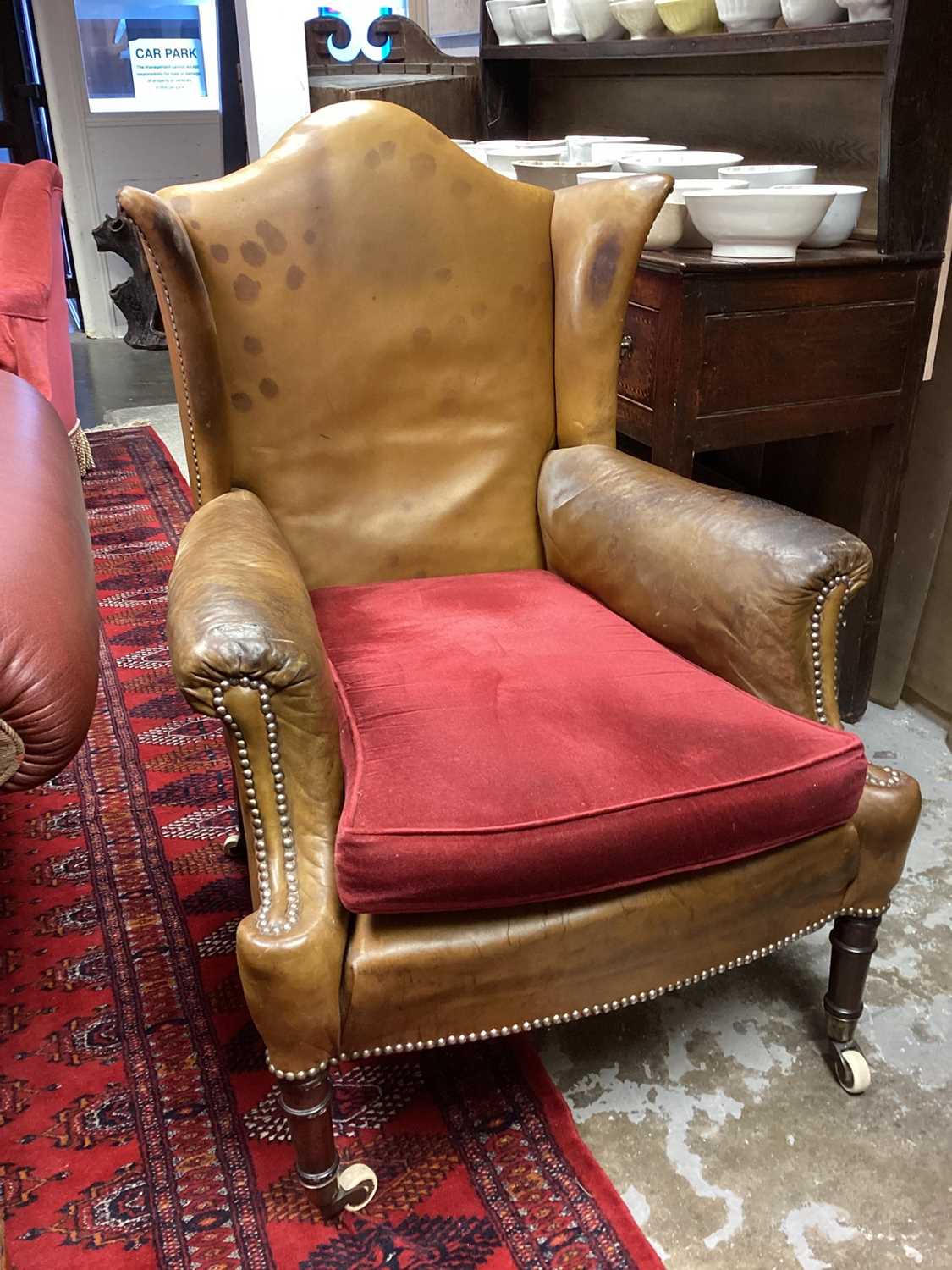 Early 19th century leather upholstered wing armchair, raised on ring turned legs and castors - Image 2 of 13
