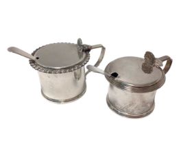 Two silver mustard pots and a pair of silver plated condiment spoons