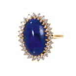Lapis lazuli and diamond cluster dress ring with an oval lapis lazuli surrounded by a border of bril