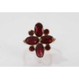 George III garnet cluster with flat cut garnets in foil backed setting on later gold ring mount