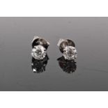 Pair of diamond single stone stud earrings, each with a round brilliant cut diamond in four claw 14c