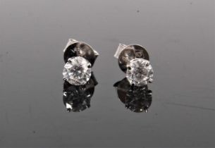 Pair of diamond single stone stud earrings, each with a round brilliant cut diamond in four claw 14c