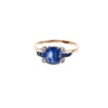 Art Deco sapphire and diamond ring with a cushion shape mixed cut blue sapphire flanked by four diam