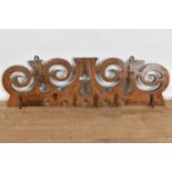 18th/19th century French chestnut hanging rack, of pierced scrolling form, 75cm wide