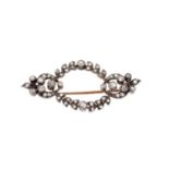 Late Victorian diamond brooch with an open work garland of old cut and rose cut diamonds in a silver