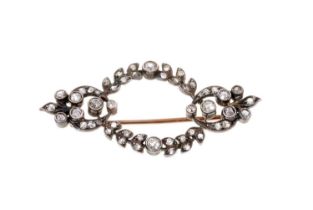 Late Victorian diamond brooch with an open work garland of old cut and rose cut diamonds in a silver