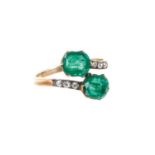 Antique emerald and diamond cross-over ring