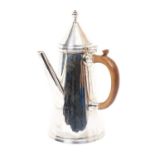 George V silver "teapot" of tapering cylindrical form, with a conical cover and a straight spout,