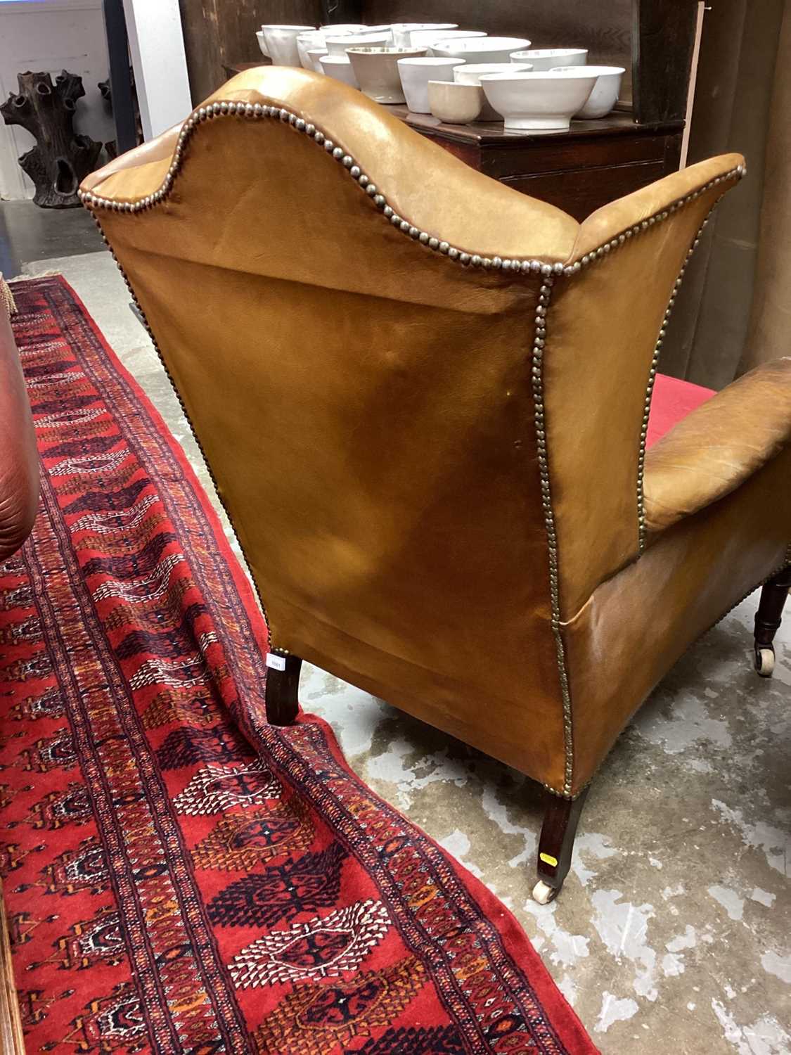 Early 19th century leather upholstered wing armchair, raised on ring turned legs and castors - Image 12 of 13
