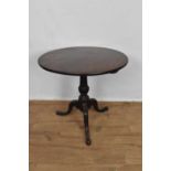 George III mahogany and later carved occasional table, with solid circular tilt top on fluted carved
