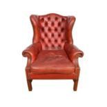 Georgian style red button leather upholstered wing armchair, on square supports