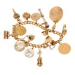 Gold charm bracelet with a collection of gold and yellow metal charms to include a gold half soverei