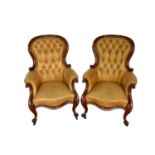 Pair of Victorian button leather upholstered armchairs, each with spoon shaped back and showwood fra