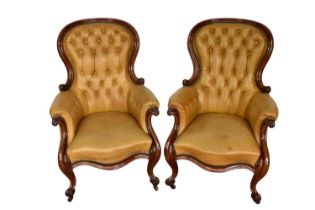 Pair of Victorian button leather upholstered armchairs, each with spoon shaped back and showwood fra